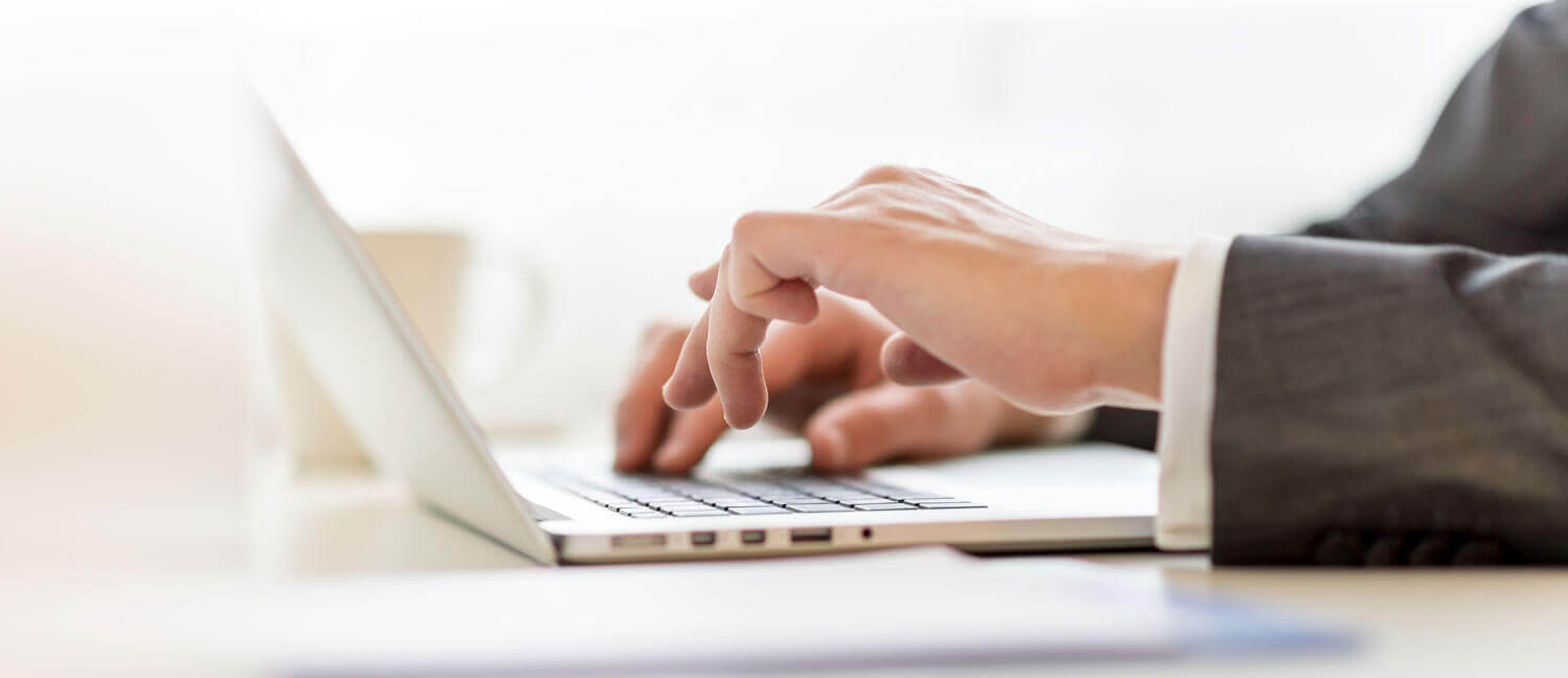 hands typing on a laptop