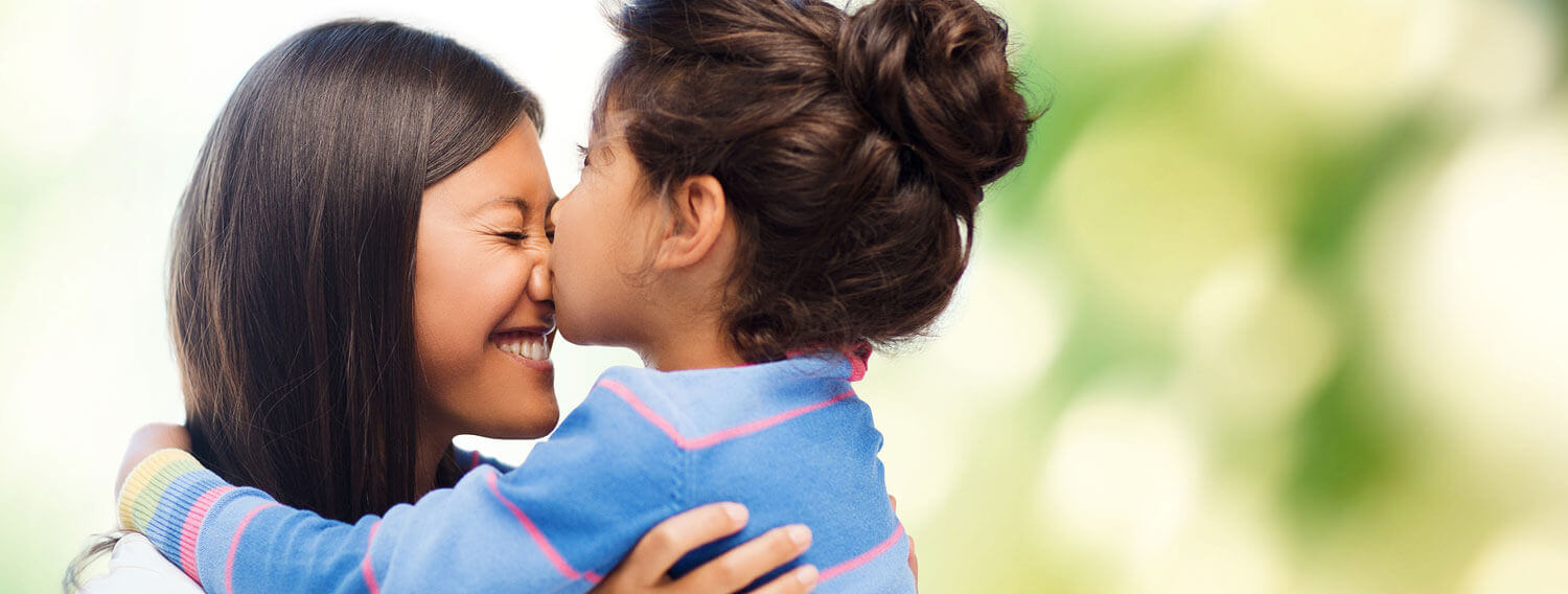 Daughter kissing her mother on the nose