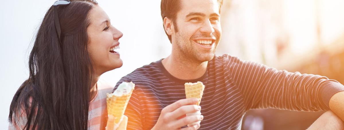 Couple eating ice cream cones together