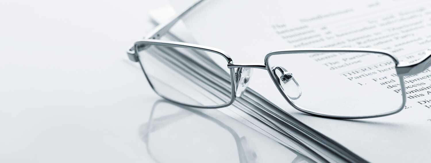 Seeing glasses resting on some documents