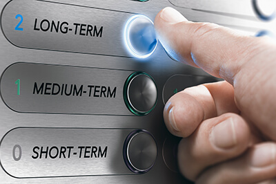 image of a person hitting a button that says long term beneath two buttons that say medium term and short term