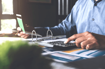 Business owner calculating accounting statements