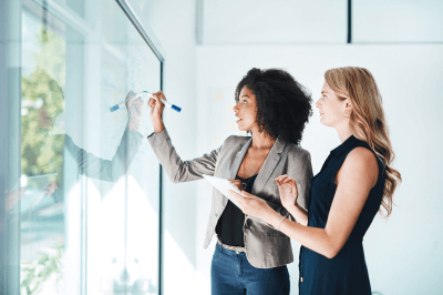 Business owners planning their business's brand on a whiteboard