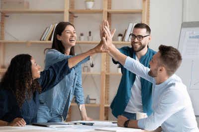 Group of coworkers giving each other a high-five