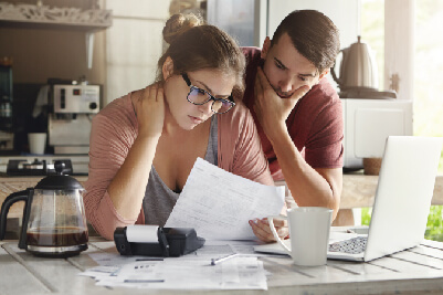 Young couple looking at financial documents