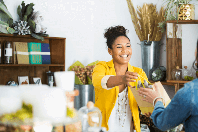 Business owner handing a bag to a customer