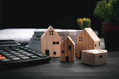 tiny wooden homes next to a calculator