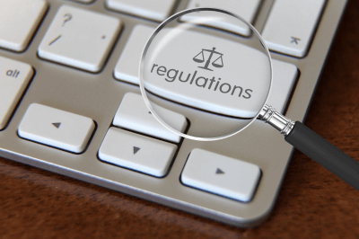 Magnifying glass showing the word regulations