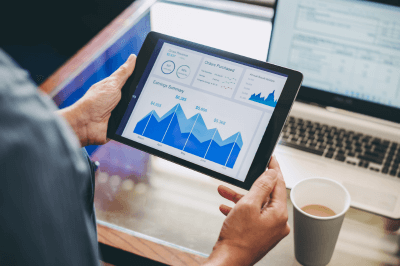 Business owner looking at graphs on a tablet