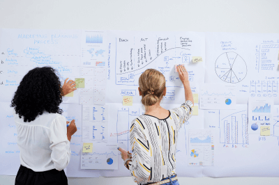 Business owners keeping track of ROI through various charts