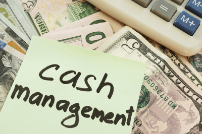 Sticky note on cash that says cash management