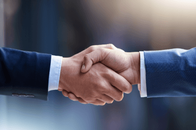 Two men in suits shaking hands