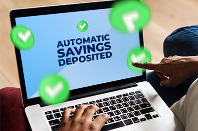 Laptop screen saying Automatic Savings Deposited