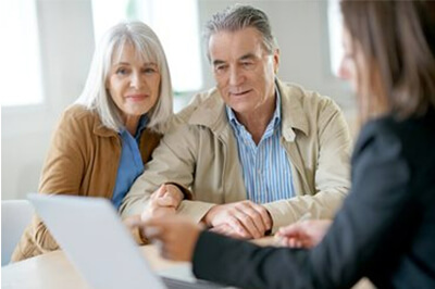 older couple sitting with financial advisor