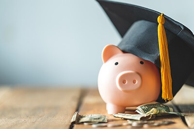 Piggy Bank wearing a college graduation hat