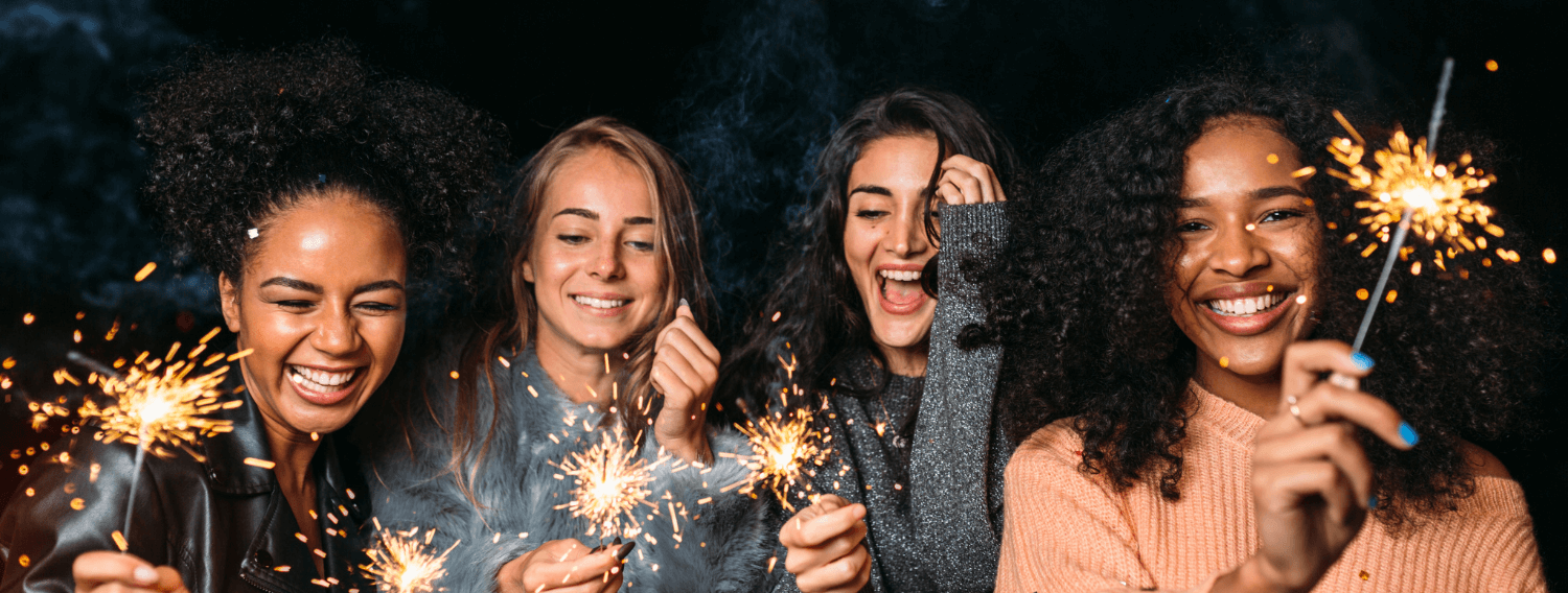 happy friends holding sparklers