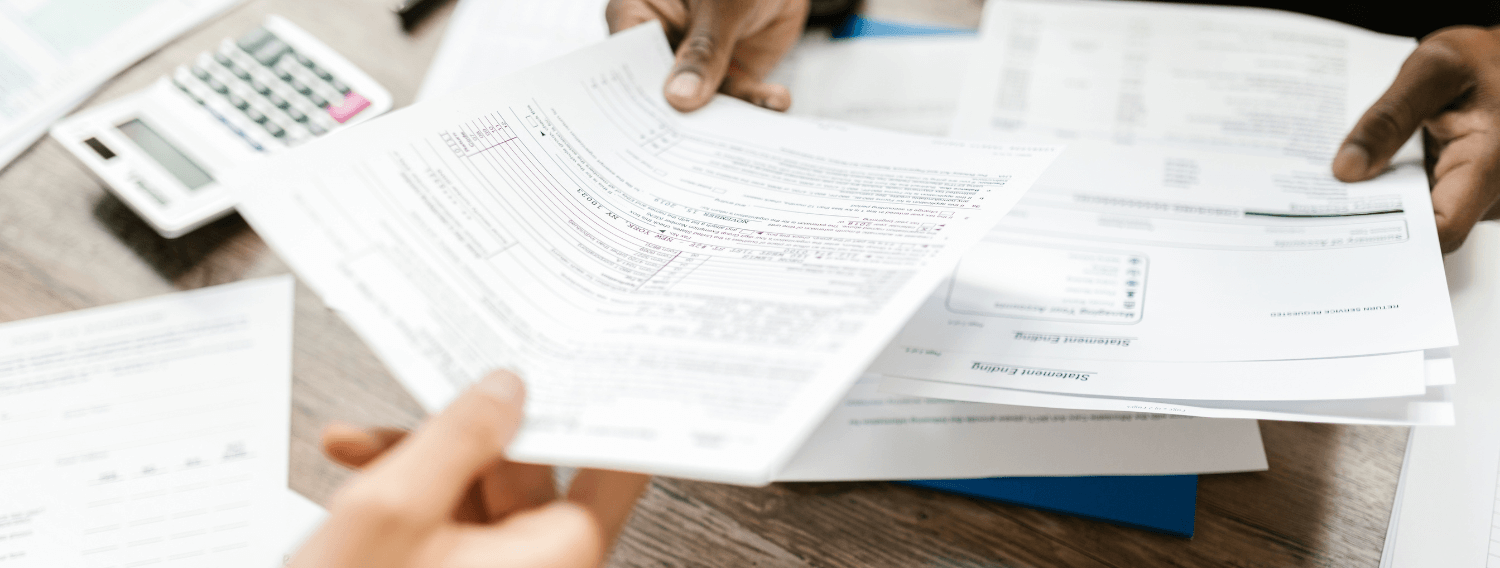 Tax document being passed from one person to the other