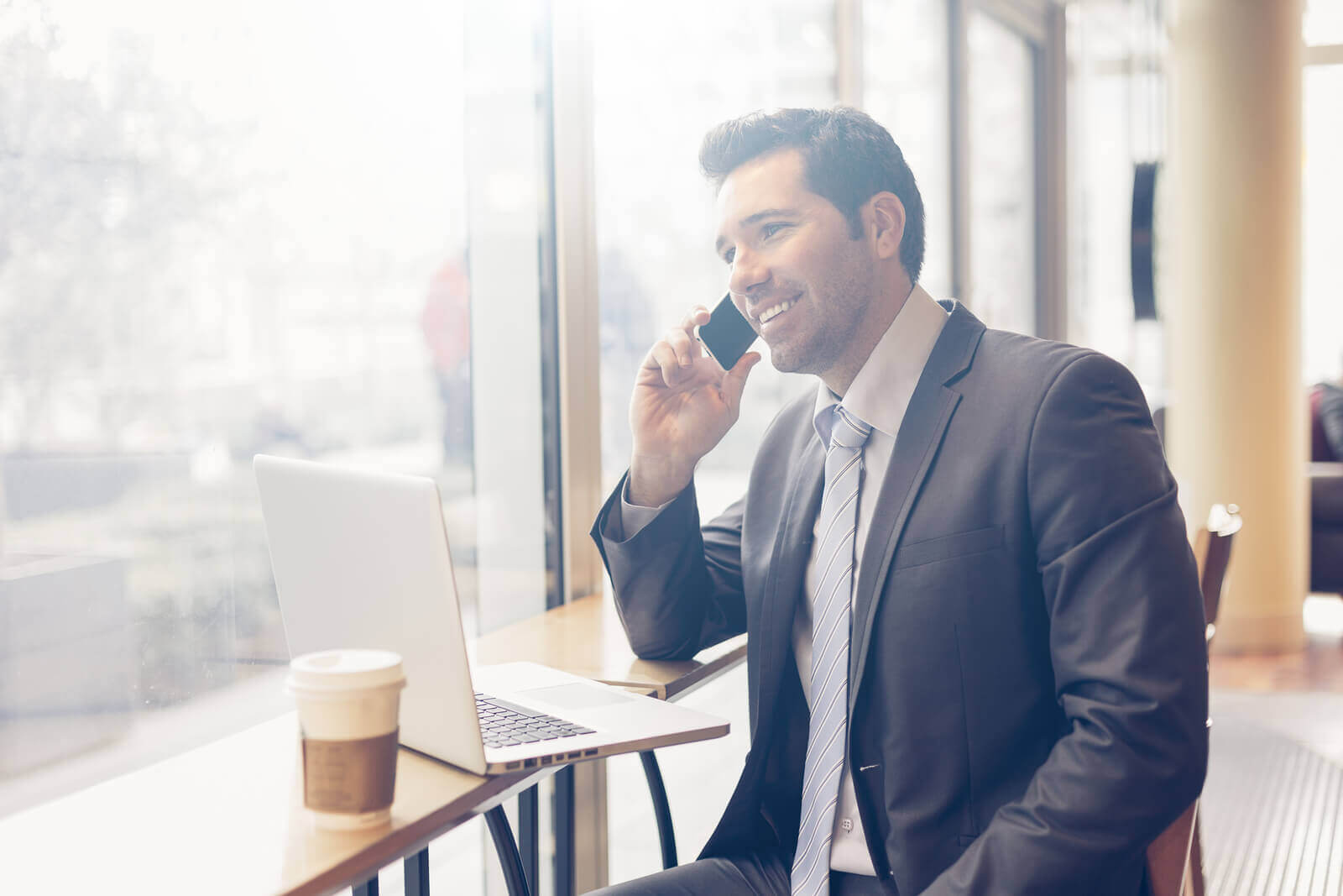 Man talking on the phone in a coffee shop