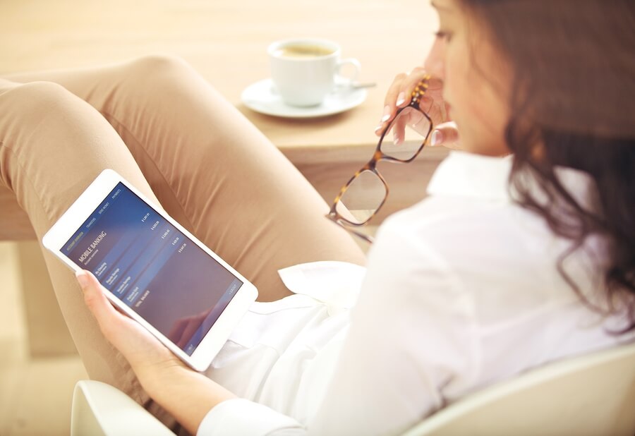 lady looking at the tablet in her hand