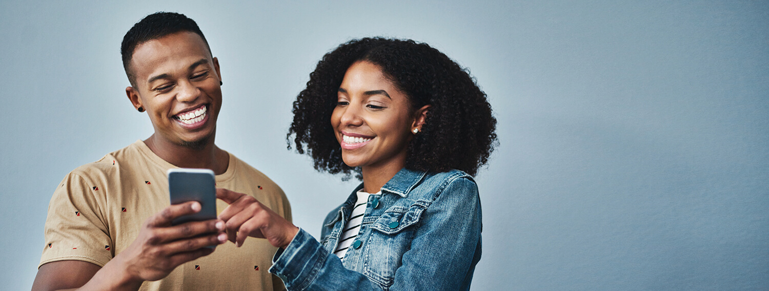 Happy couple looking at a phone together