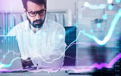 middle age man looking at stock chart on laptop