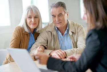 older couple sitting with financial advisor