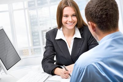 young man talking to young woman about investing